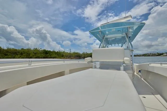  Yacht Photos Pics Invincible 36 boat, 2015 model, on calm water under a partly cloudy sky.