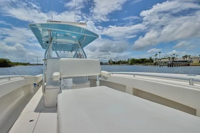  Yacht Photos Pics Invincible 36 boat, 2015 model, on calm water under a partly cloudy sky.