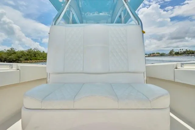  Yacht Photos Pics White cushioned seating on 2015 Invincible 36 boat, under blue sky.