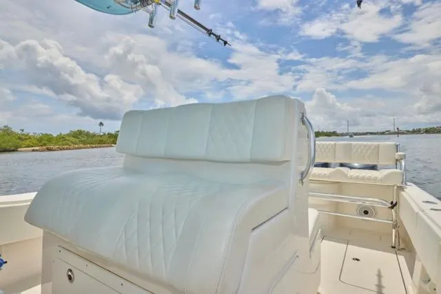  Yacht Photos Pics Invincible 36 boat, 2015 model, featuring white cushioned seating on a sunny day.