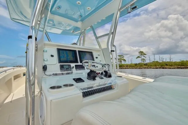  Yacht Photos Pics Cockpit of 2015 Invincible 36 boat with modern navigation equipment and steering wheel.