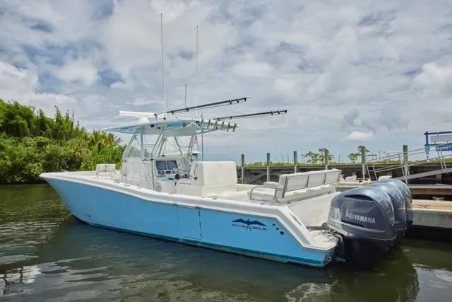  Yacht Photos Pics 2015 Invincible 36 boat docked with Yamaha engines, under a cloudy sky.