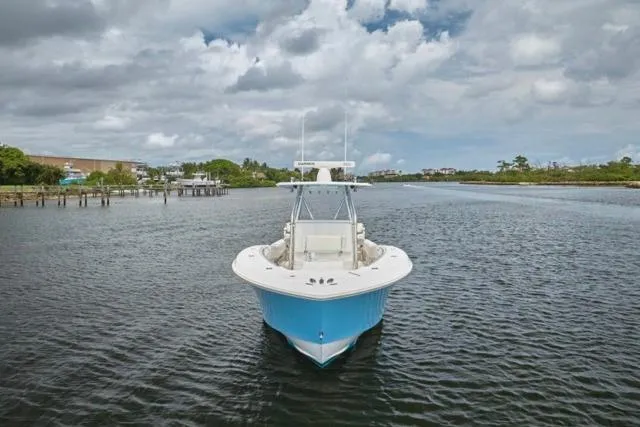  Yacht Photos Pics 2015 Invincible 36 boat on calm water under cloudy sky.