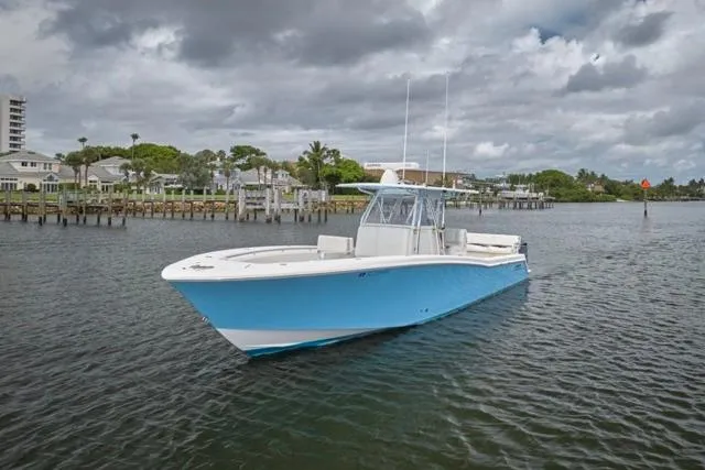  Yacht Photos Pics 2015 Invincible 36 boat on calm water under cloudy sky.