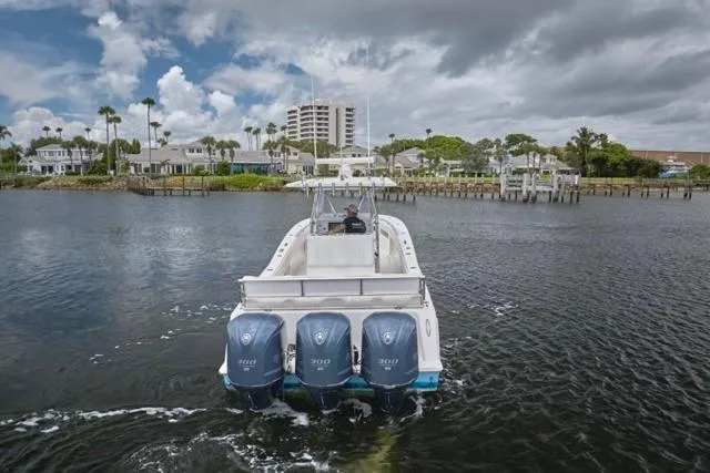  Yacht Photos Pics 2015 Invincible 36 boat with triple engines cruising on a scenic waterway.