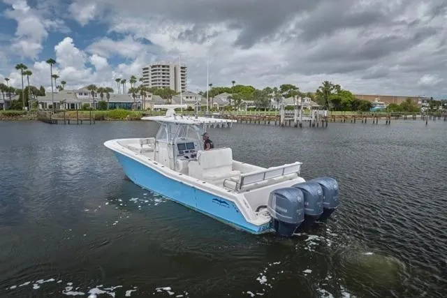  Yacht Photos Pics 2015 Invincible 36 boat with triple engines on a calm waterway.