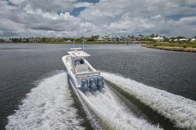  Yacht Photos Pics Invincible 36 boat cruising on water, 2015 model, with three powerful engines.