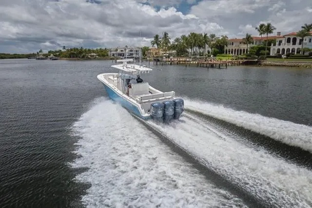  Yacht Photos Pics 2015 Invincible 36 boat cruising on a scenic waterway with waterfront homes.