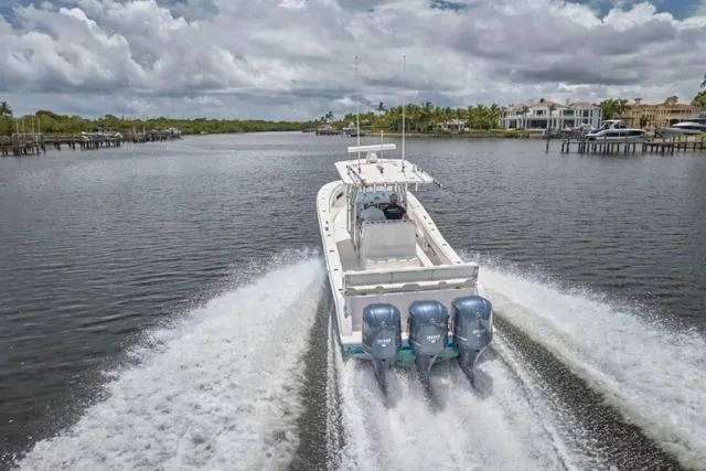  Yacht Photos Pics 2015 Invincible 36 boat cruising on a scenic waterway with triple engines.