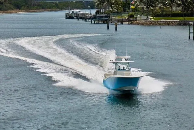  Yacht Photos Pics Invincible 36 boat cruising on a scenic waterway, 2015 model.