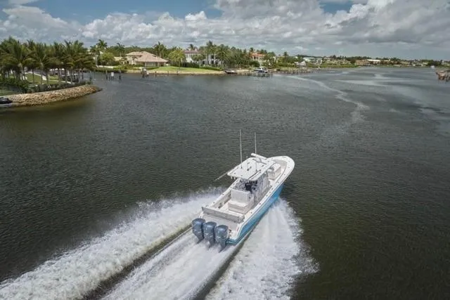  Yacht Photos Pics Invincible 36 boat cruising on a scenic waterway, 2015 model, with powerful engines.