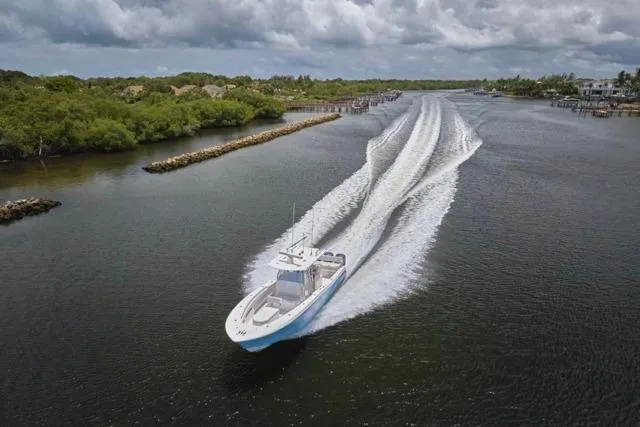  Yacht Photos Pics Invincible 36 boat cruising through a scenic waterway, 2015 model.