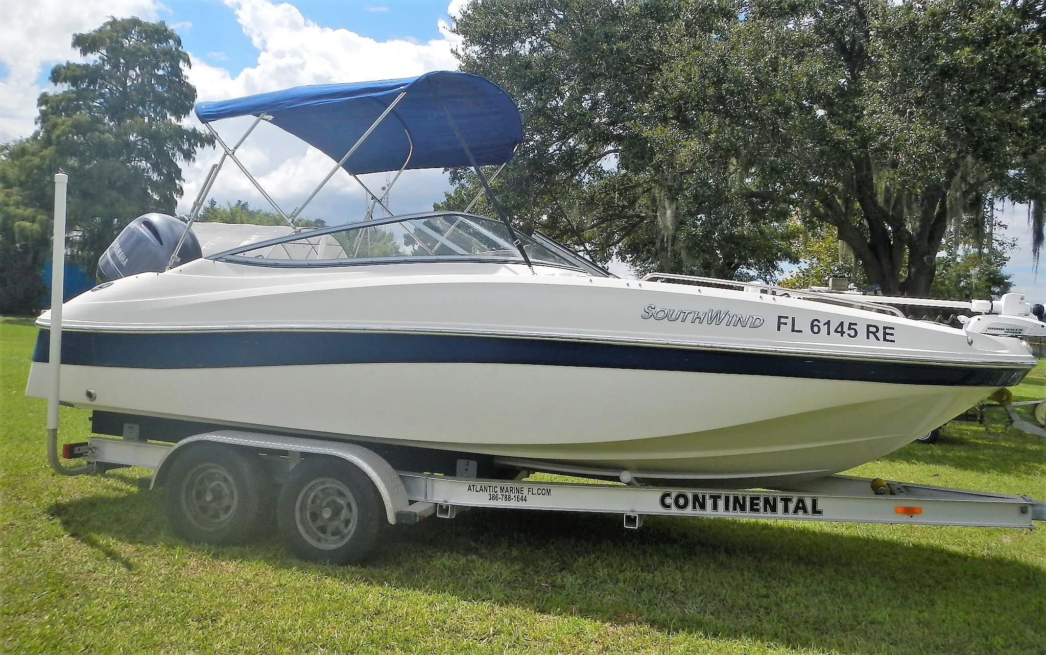 2016 SouthWind 212 SD boat on a Continental trailer with blue canopy.