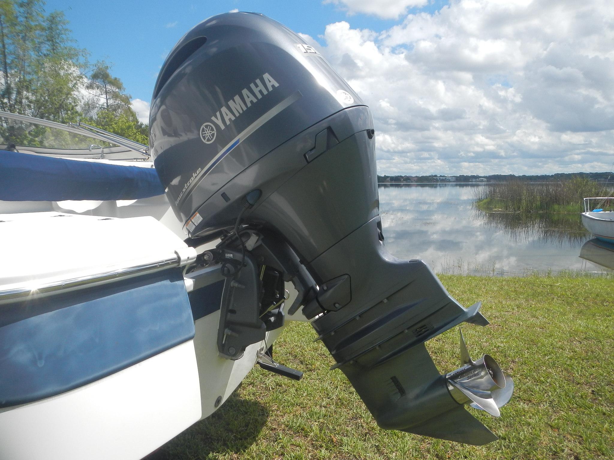 2016 SouthWind 212 SD boat with Yamaha outboard motor by a lake.