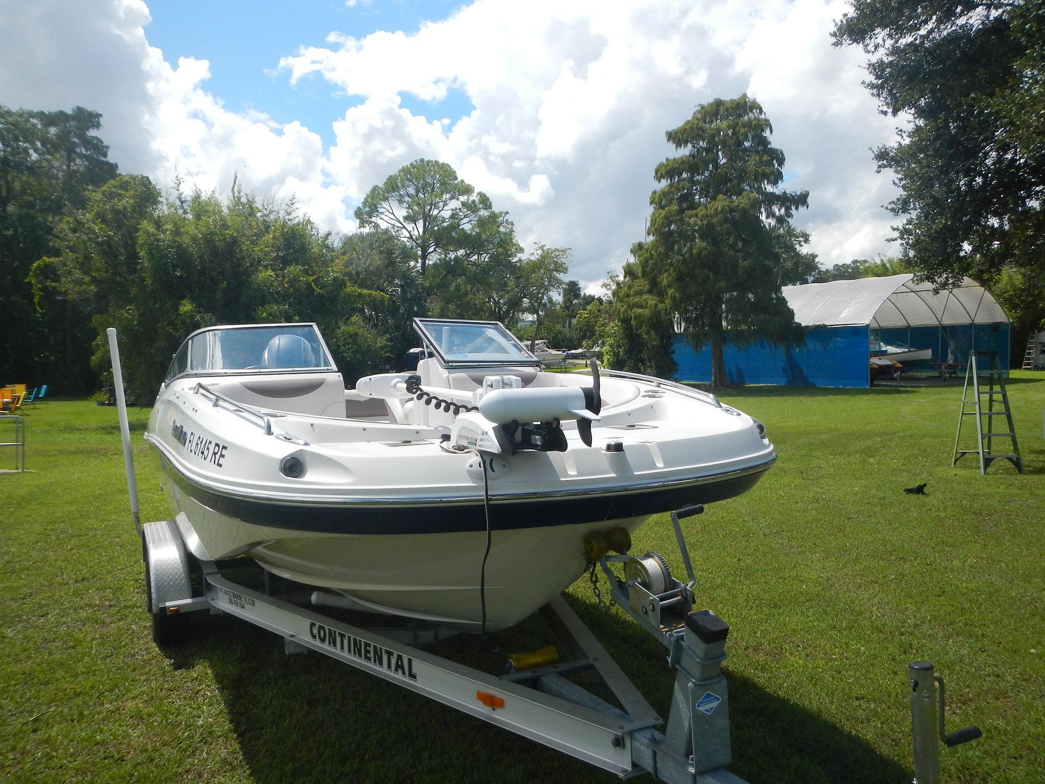 2016 SouthWind 212 SD boat on Continental trailer in grassy yard.