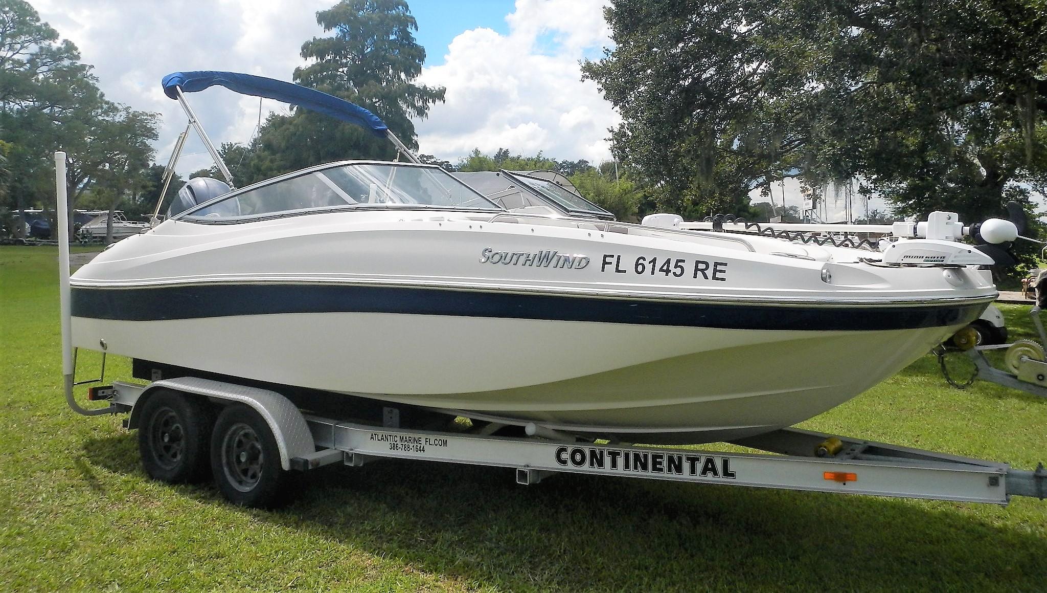 2016 SouthWind 212 SD boat on a Continental trailer, parked on grass.