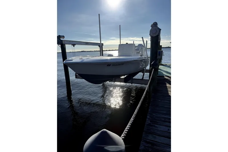  Yacht Photos Pics 2024 Contender 25 Bay boat docked on a sunny day by the water.