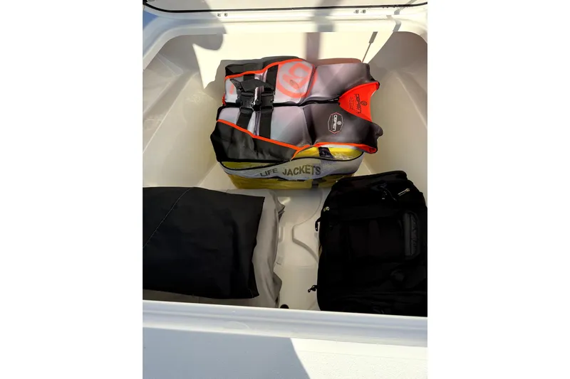  Yacht Photos Pics Storage compartment of 2024 Contender 25 Bay boat with life jackets and bags.