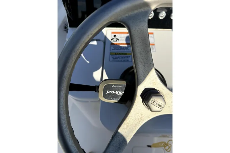 Yacht Photos Pics Steering wheel of 2024 Contender 25 Bay boat with pro-trim control.