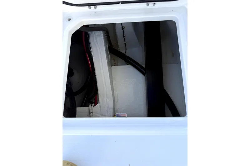  Yacht Photos Pics 2024 Contender 25 Bay boat storage compartment with wiring and equipment.