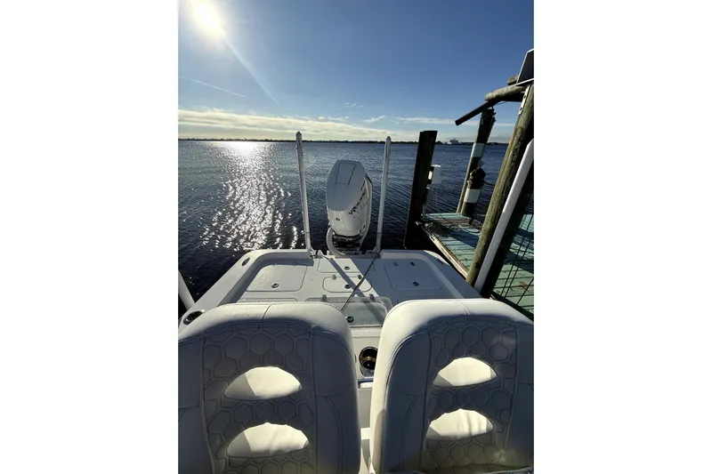  Yacht Photos Pics 2024 Contender 25 Bay boat docked, sunlit water view, modern seating.