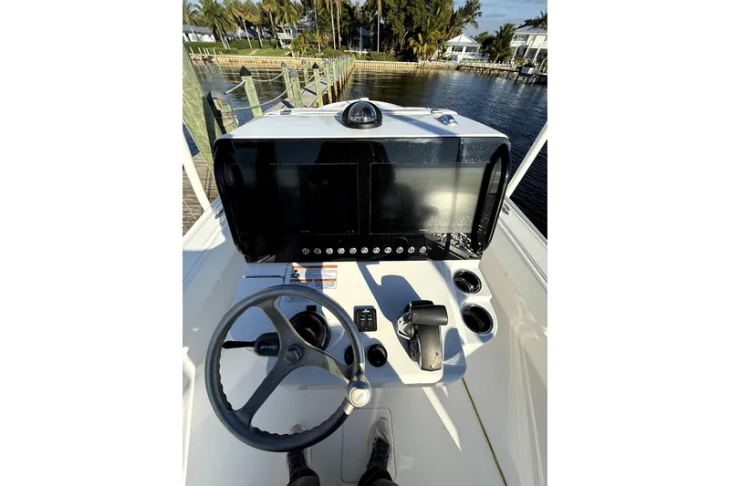  Yacht Photos Pics 2024 Contender 25 Bay boat dashboard with steering wheel and control panel.