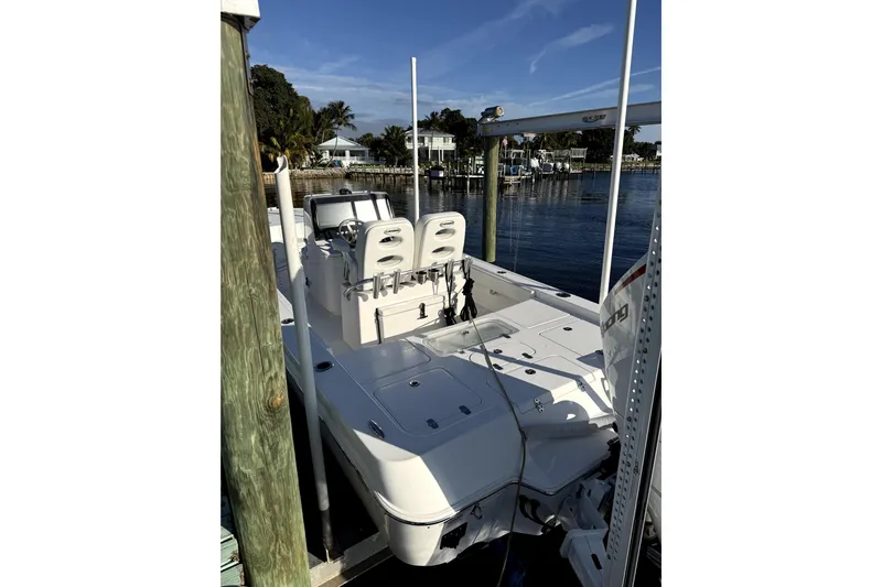  Yacht Photos Pics 2024 Contender 25 Bay boat docked, showcasing sleek design and spacious deck.