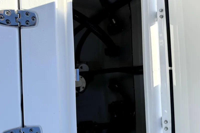  Yacht Photos Pics 2024 Contender 25 Bay boat compartment with visible hinges and interior components.