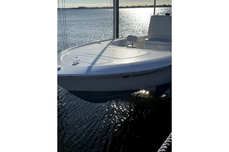  Yacht Photos Pics 2024 Contender 25 Bay boat on water, reflecting sunlight.