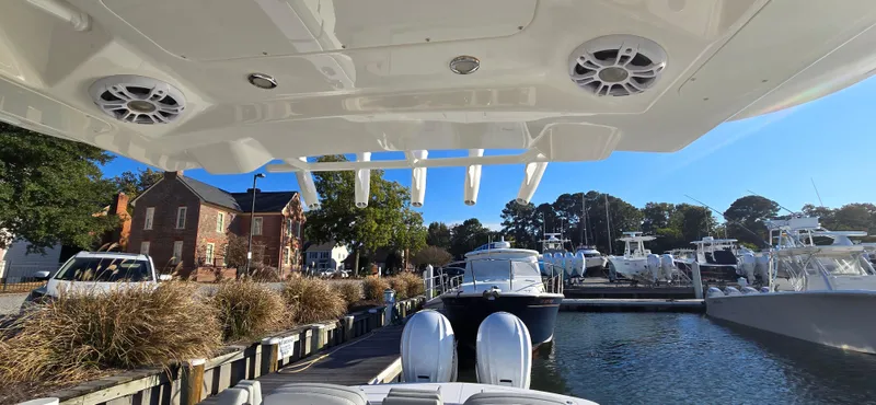 Wound Tight Yacht Photos Pics 2021 Regulator 34 Center Console docked at a marina with clear blue skies.