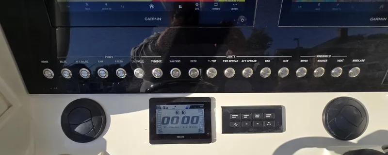 Wound Tight Yacht Photos Pics 2021 Regulator 34 Center Console dashboard with Garmin displays and control buttons.