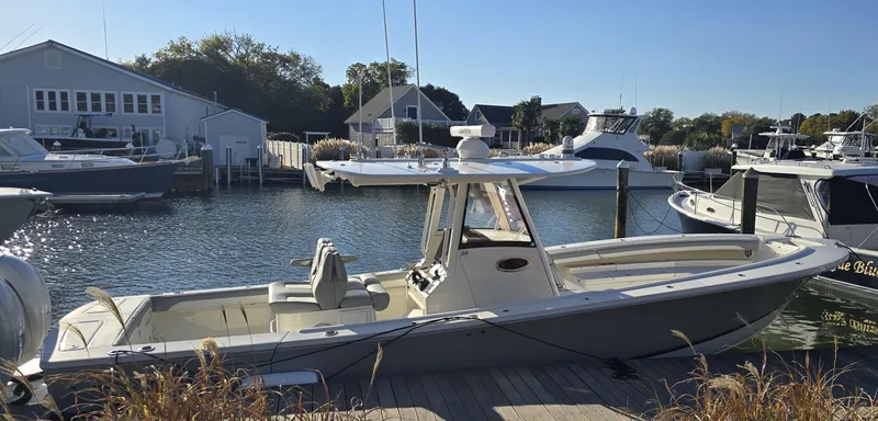 Wound Tight Yacht Photos Pics 2021 Regulator 34 Center Console boat docked in a marina.