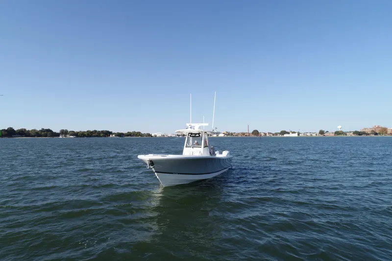 Wound Tight Yacht Photos Pics 2021 Regulator 34 Center Console boat on open water under clear blue sky.