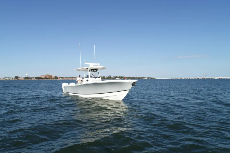 Wound Tight Yacht Photos Pics 2021 Regulator 34 Center Console boat on open water under clear blue sky.