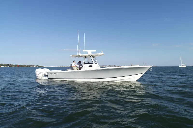 Wound Tight Yacht Photos Pics 2021 Regulator 34 Center Console boat on open water under clear blue sky.