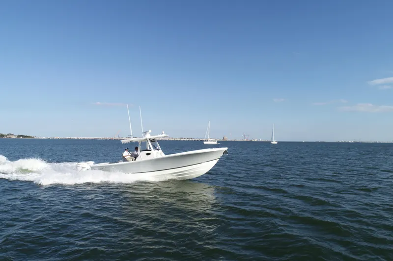 Wound Tight Yacht Photos Pics 2021 Regulator 34 Center Console boat cruising on open water under clear skies.