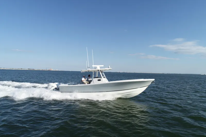 Wound Tight Yacht Photos Pics 2021 Regulator 34 Center Console boat cruising on open water.