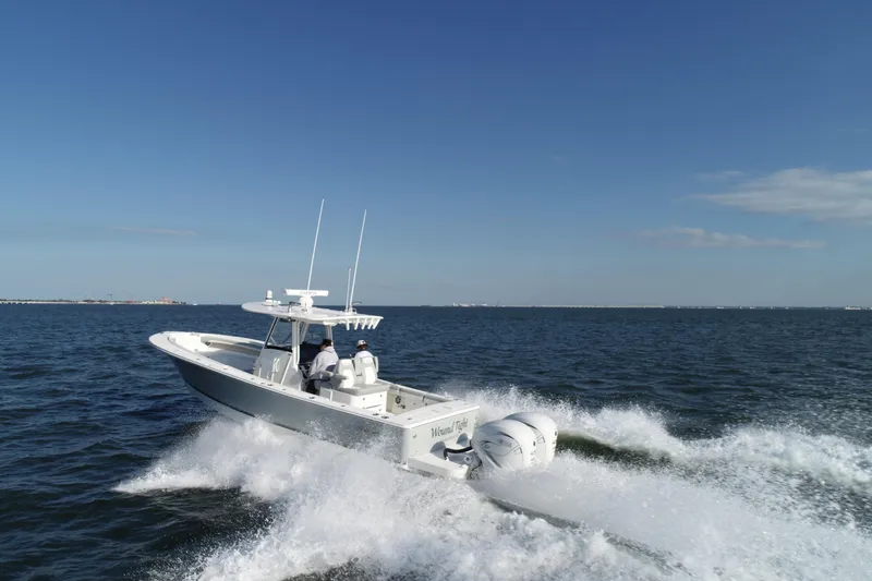 Wound Tight Yacht Photos Pics 2021 Regulator 34 Center Console boat cruising on open water.