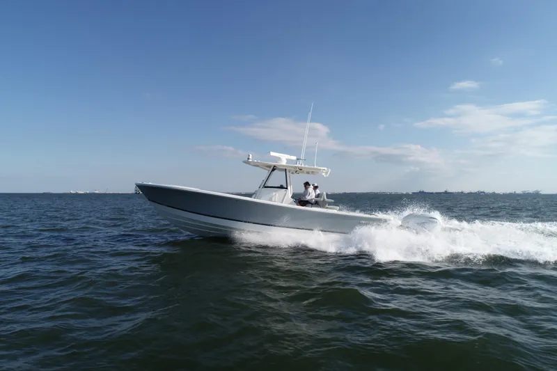 Wound Tight Yacht Photos Pics 2021 Regulator 34 Center Console boat cruising on open water.