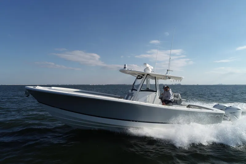 Wound Tight Yacht Photos Pics 2021 Regulator 34 Center Console boat cruising on open water.