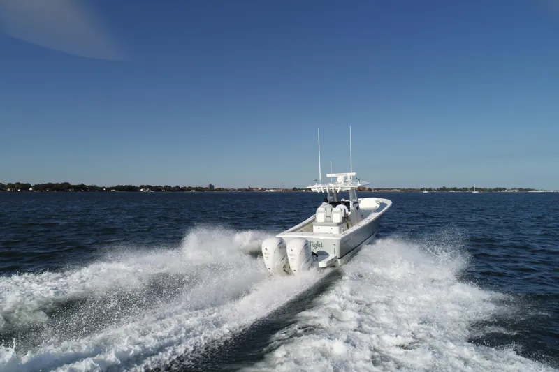 Wound Tight Yacht Photos Pics 2021 Regulator 34 Center Console boat cruising on open water.