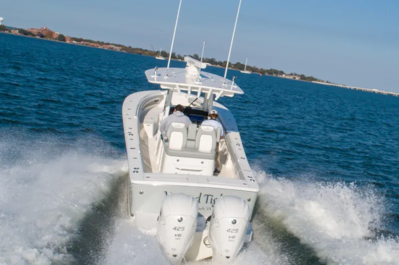 Wound Tight Yacht Photos Pics 2021 Regulator 34 Center Console boat cruising on open water.