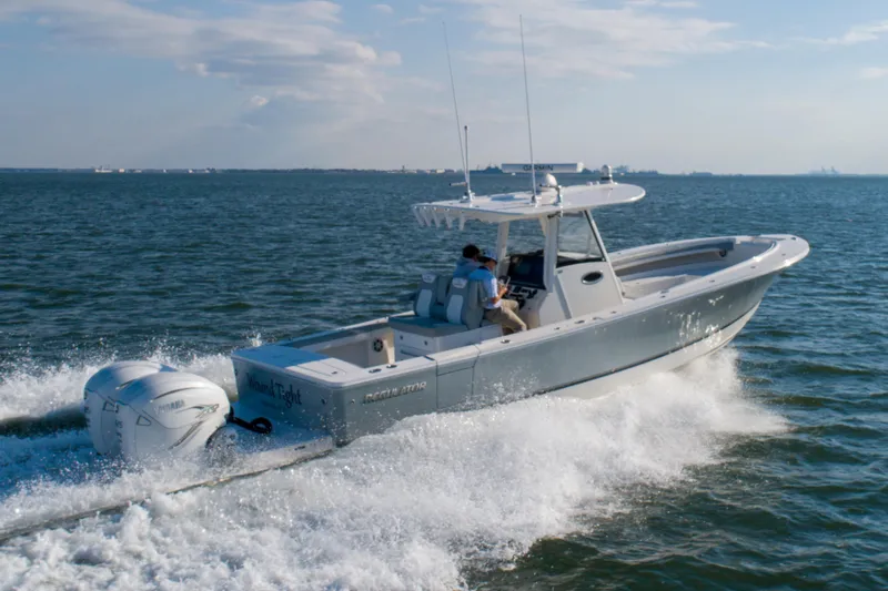 Wound Tight Yacht Photos Pics 2021 Regulator 34 Center Console boat cruising on open water.