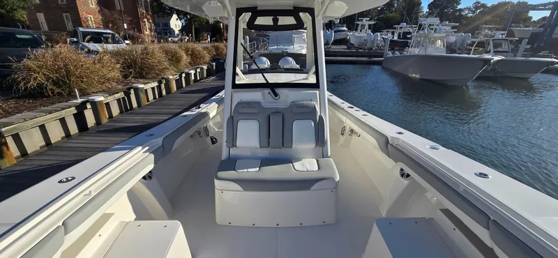 Wound Tight Yacht Photos Pics 2021 Regulator 34 Center Console boat docked at marina, showcasing spacious seating and sleek design.