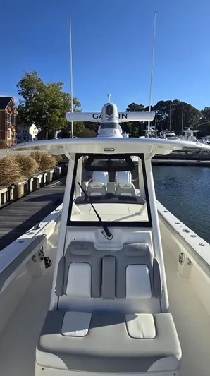 Wound Tight Yacht Photos Pics 2021 Regulator 34 Center Console boat docked in a marina under clear blue skies.
