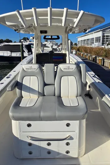Wound Tight Yacht Photos Pics 2021 Regulator 34 Center Console boat with dual seating and storage, docked at a marina.