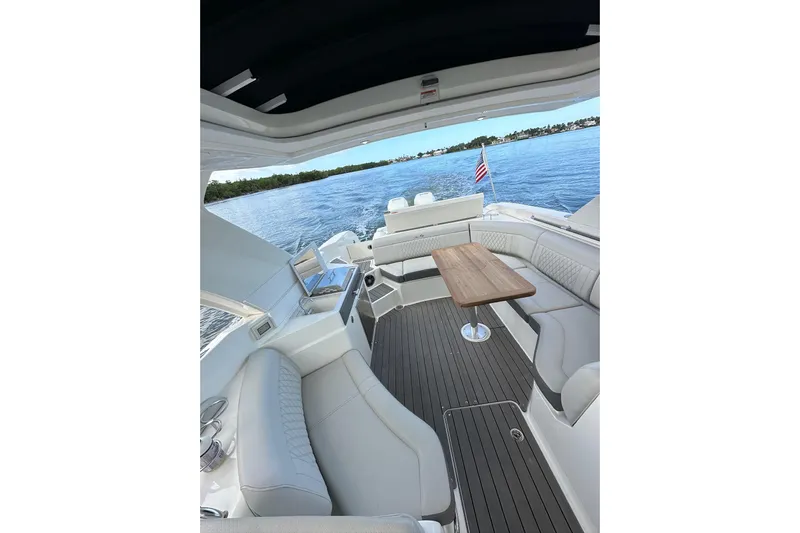 Northeast Yacht Photos Pics 2022 Sea Ray SLX 350 Outboard interior with elegant seating and wooden table on open water.