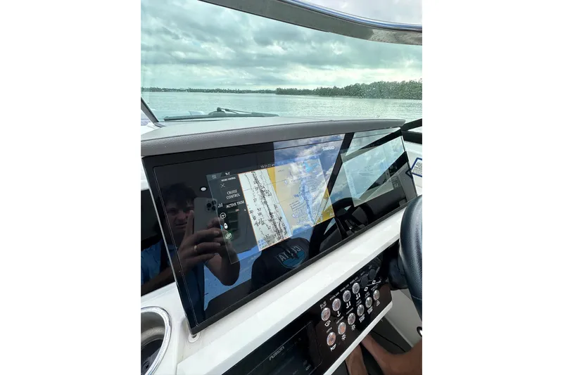 Northeast Yacht Photos Pics 2022 Sea Ray SLX 350 Outboard dashboard with navigation display on a calm water backdrop.