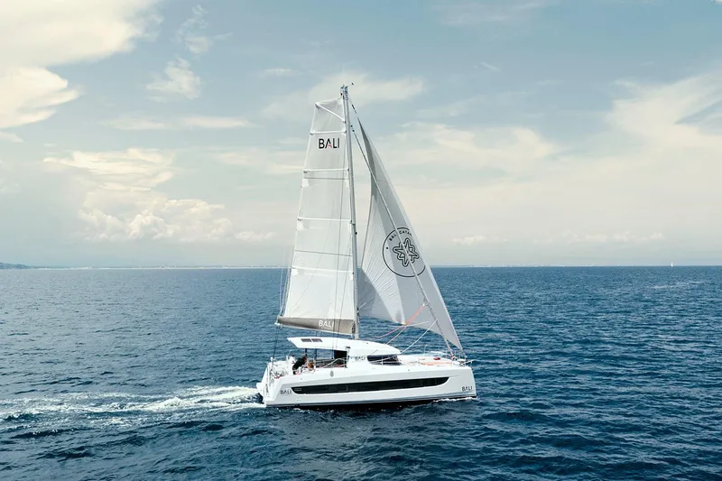  Yacht Photos Pics Sailing catamaran Bali CATSMART 2026 gliding on open sea under clear skies.