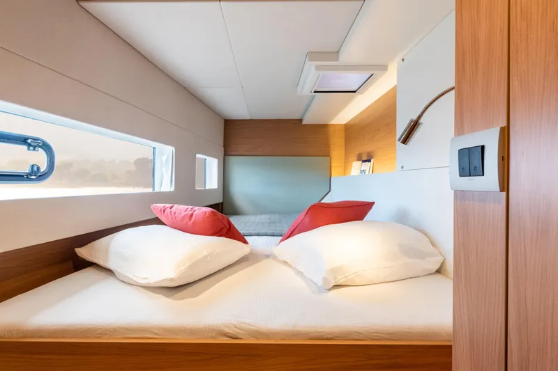  Yacht Photos Pics Luxurious cabin interior of 2026 Bali CATSMART yacht with cozy bedding and modern design.